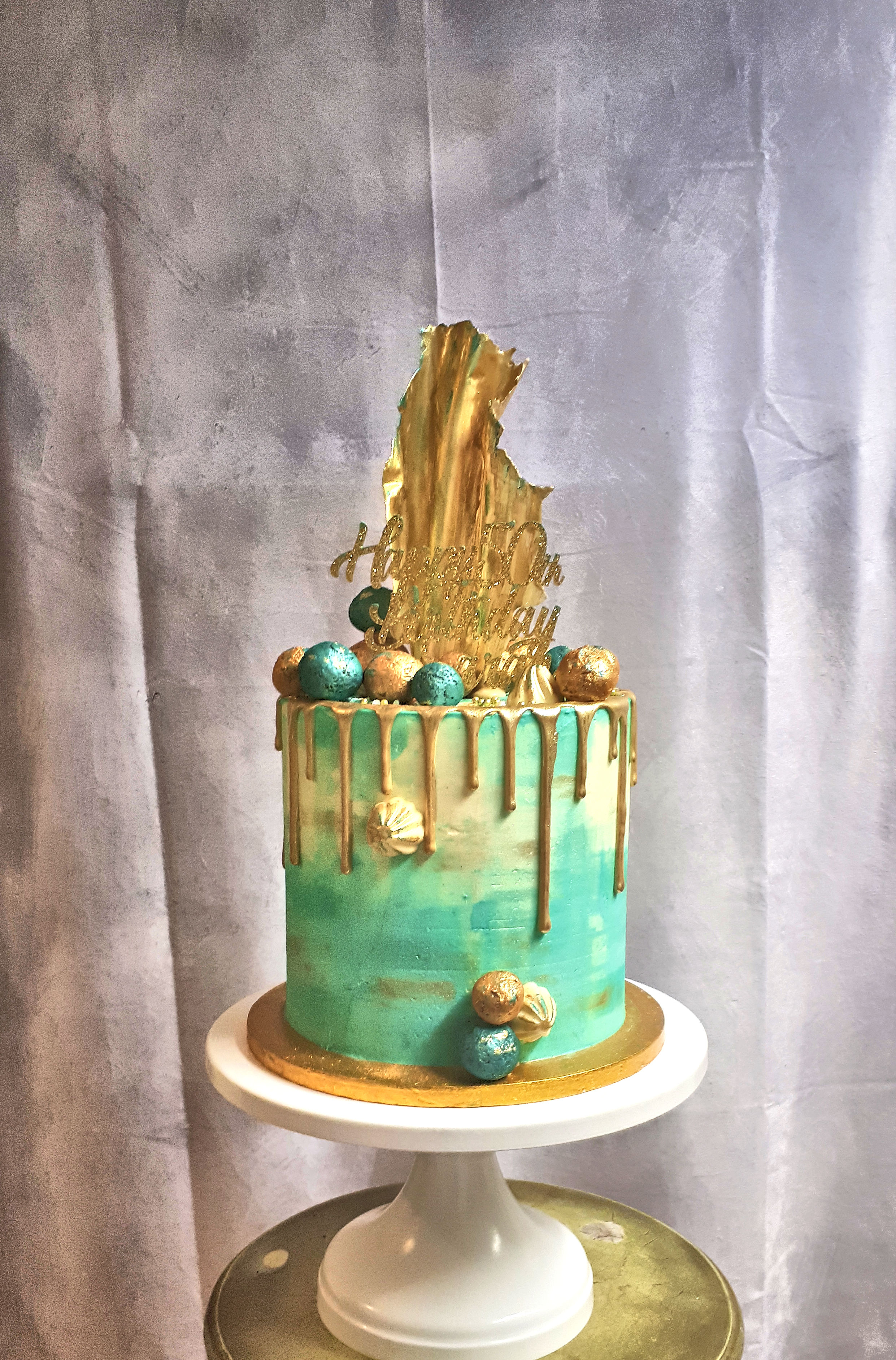 blue and gold buttercream drip cake